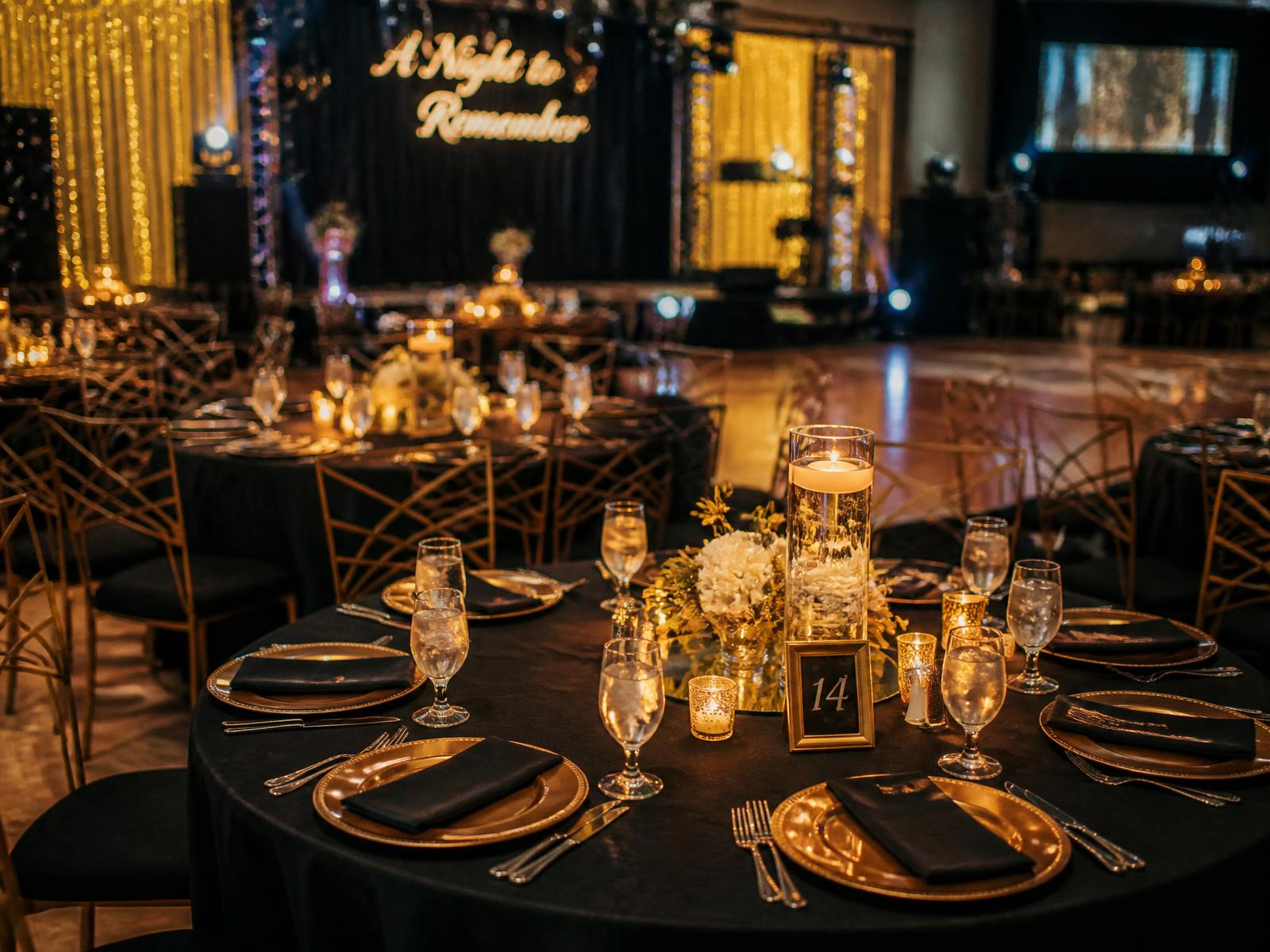 Prom dinner tables in black and gold with candlelight