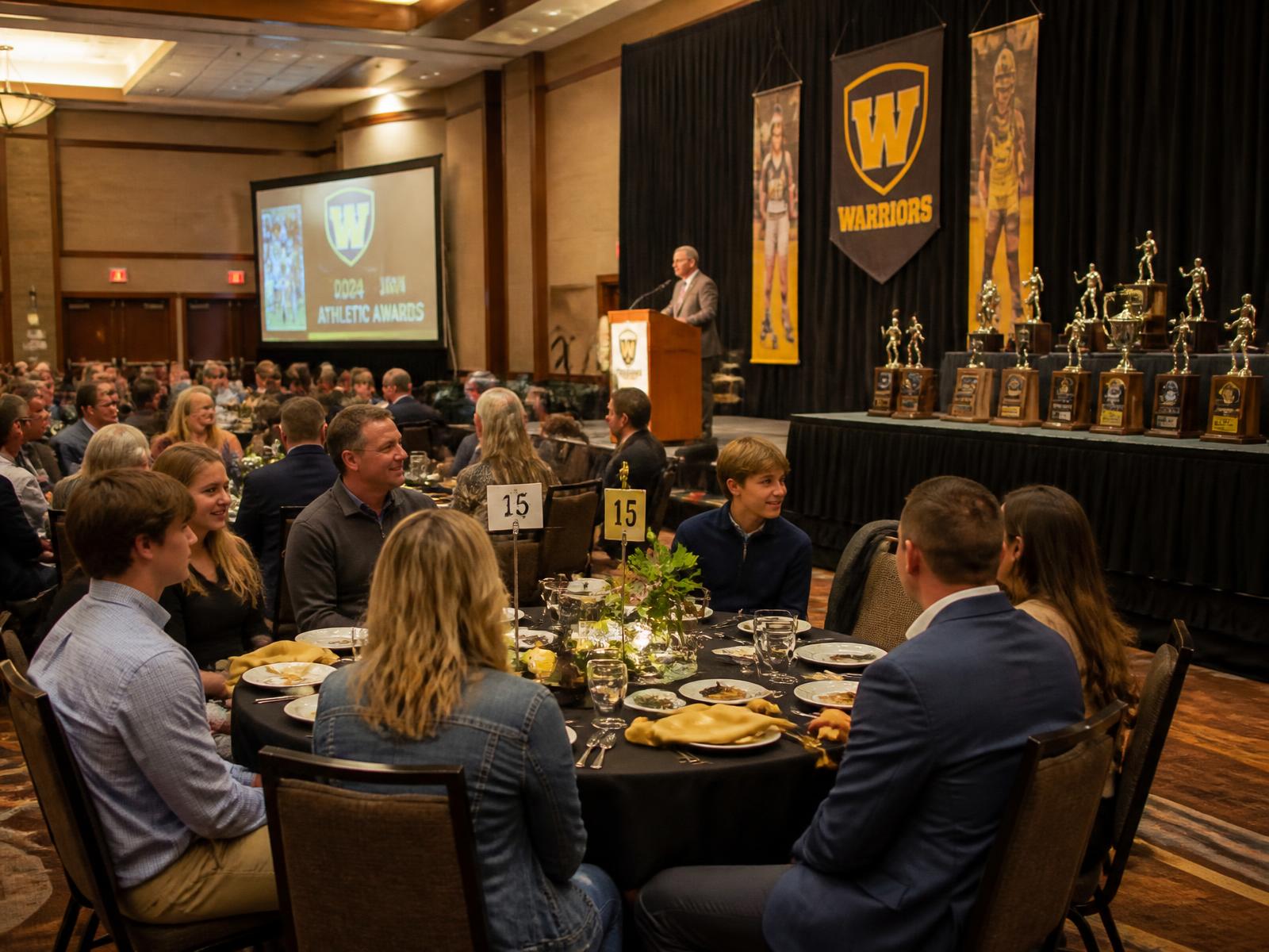 Athletic awards banquet with trophies and a stage